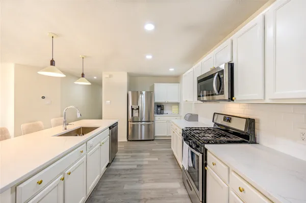 a kitchen with a sink stove and refrigerator