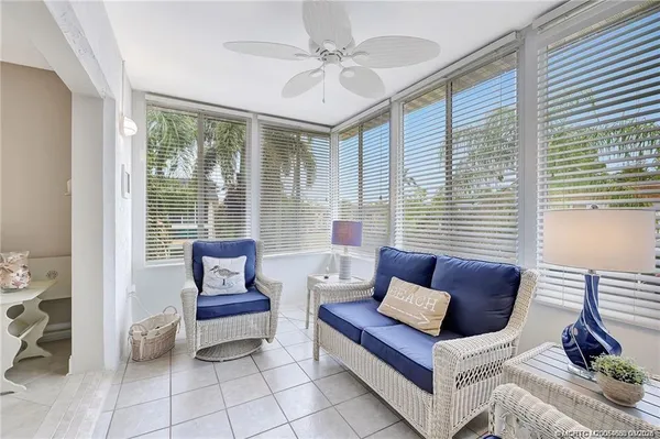 a living room with furniture and a large window with outer view