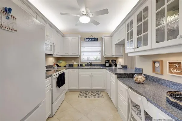 a kitchen with stainless steel appliances granite countertop a stove and cabinets