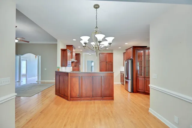 a spacious bathroom with a tub shower and mirror