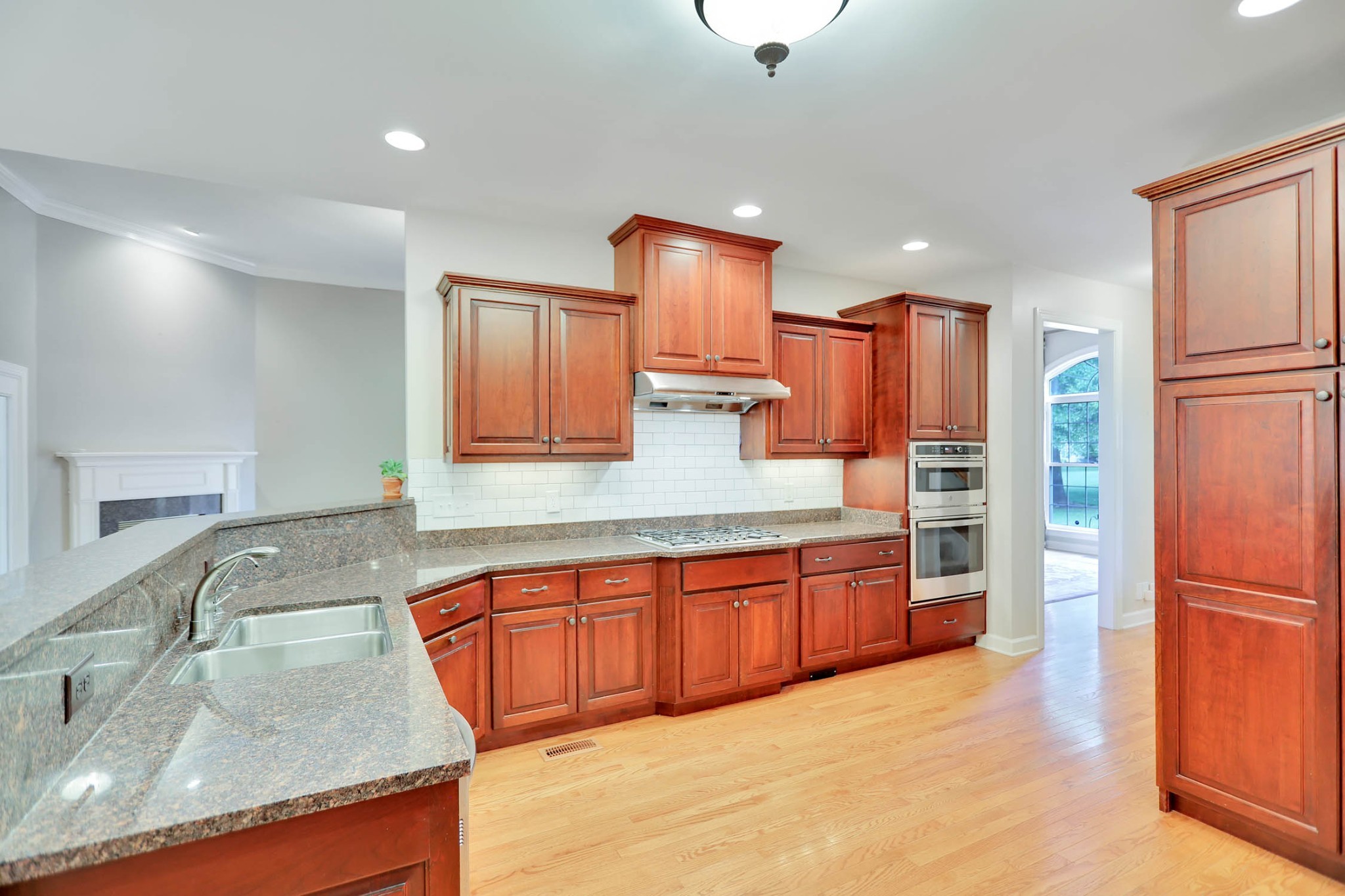 358 Spring Valley Drive Cottontown, TN 37048 - Photo 23 of 67 a large kitchen with granite countertop a sink and a refrigerator