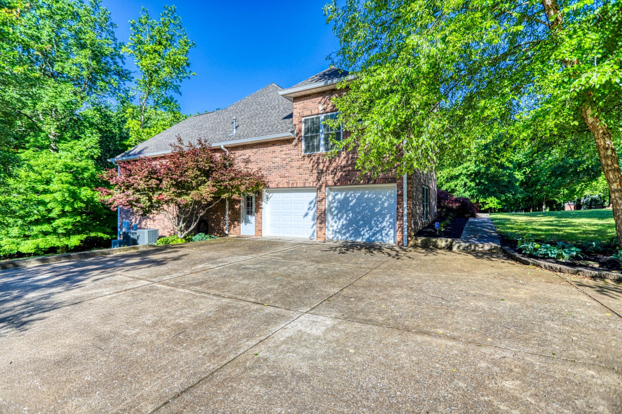 358 Spring Valley Drive Cottontown, TN 37048 - Photo 57 of 67 a front view of a house with a yard and a garage