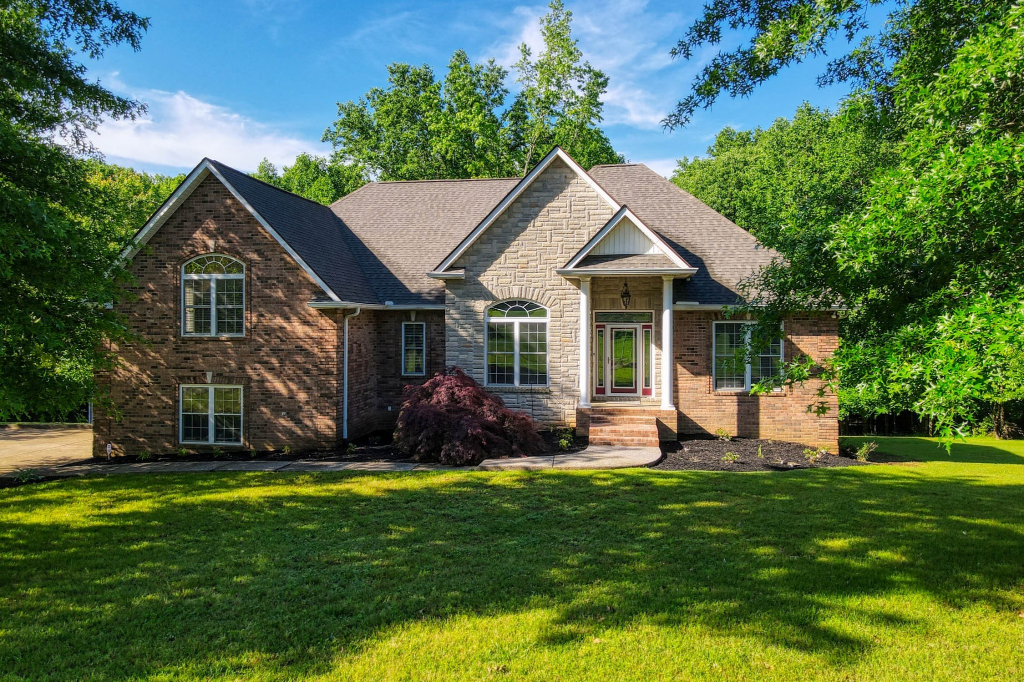 358 Spring Valley Drive Cottontown, TN 37048 - Photo 63 of 67 a front view of a house with a yard and porch