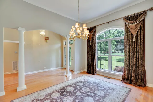 wooden floor in an empty room with a fireplace