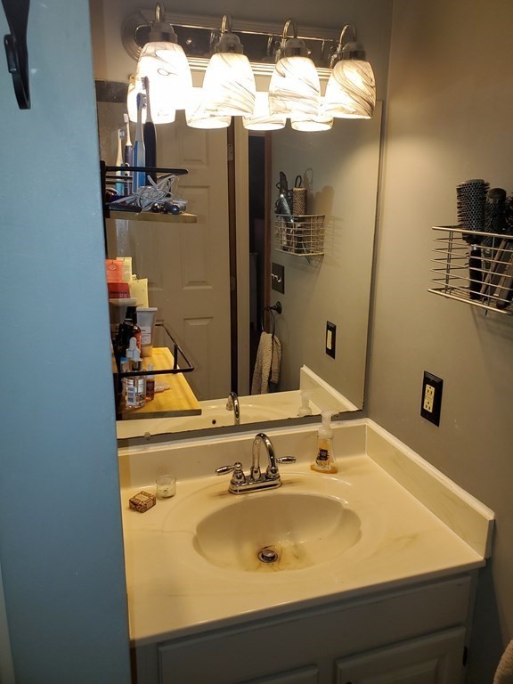 149 Dale Street, Unit S Chicopee, MA 01020 - Photo 15 of 21 a bathroom with a sink and a mirror