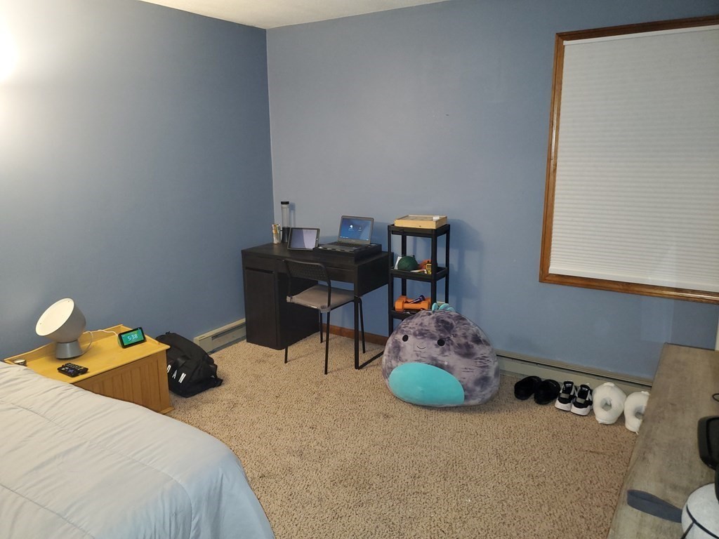 149 Dale Street, Unit S Chicopee, MA 01020 - Photo 16 of 21 a bedroom with furniture and a book shelf