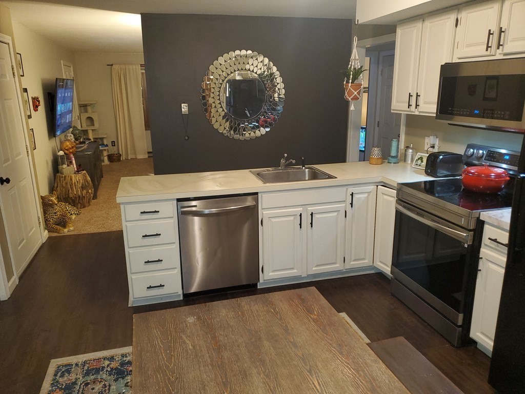 149 Dale Street, Unit S Chicopee, MA 01020 - Photo 2 of 21 a kitchen with stainless steel appliances granite countertop a stove a sink and a microwave