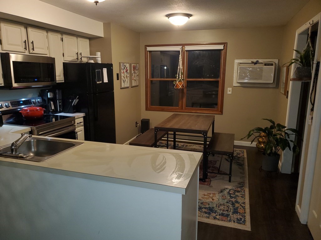 149 Dale Street, Unit S Chicopee, MA 01020 - Photo 3 of 21 a kitchen with stainless steel appliances kitchen island granite countertop a refrigerator stove and sink