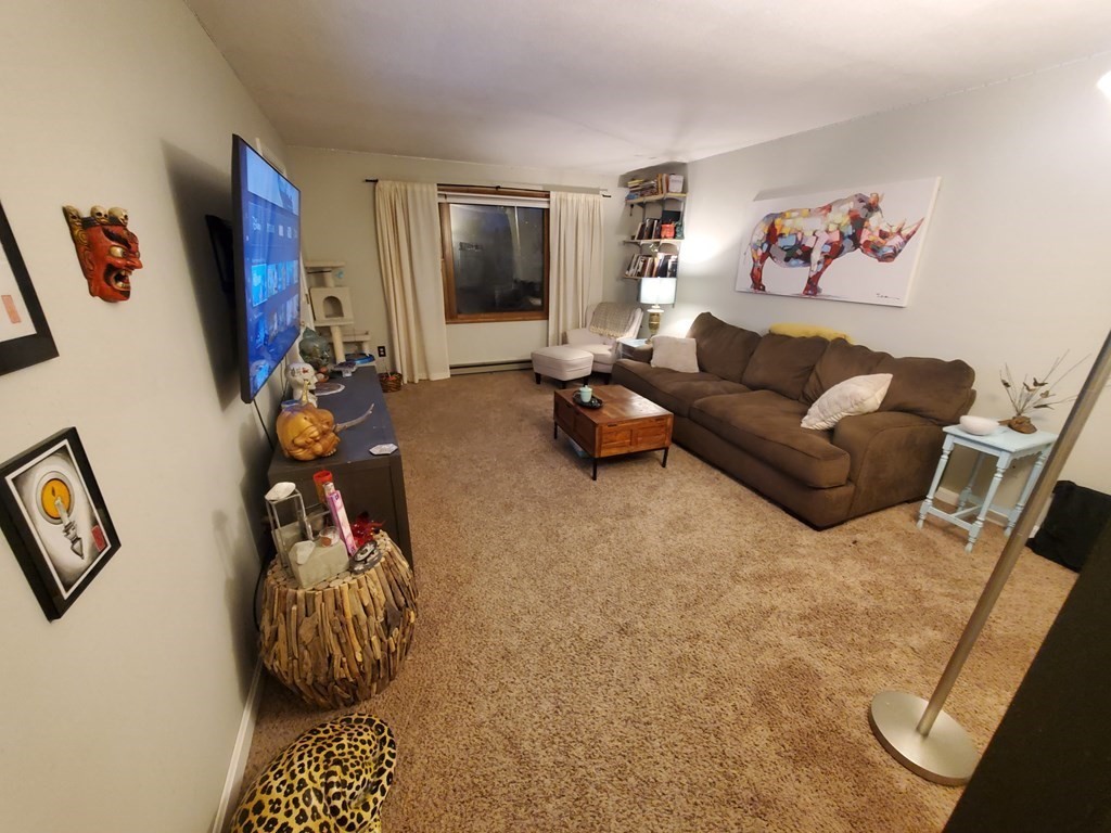 149 Dale Street, Unit S Chicopee, MA 01020 - Photo 8 of 21 a living room with furniture and a flat screen tv