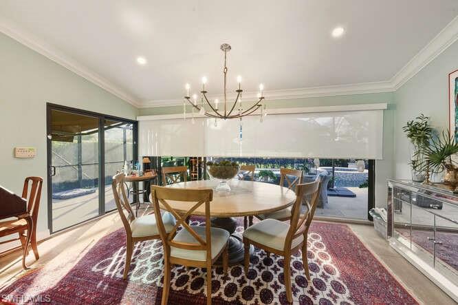 254 Edgemere Way East Naples, FL 34105 - Photo 11 of 41 Dining room with crown molding, a chandelier, and recessed lighting