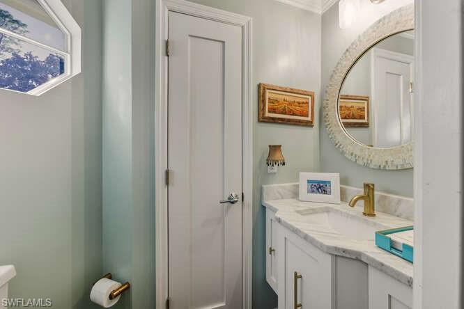 254 Edgemere Way East Naples, FL 34105 - Photo 16 of 41 Bathroom with vanity and ornamental molding