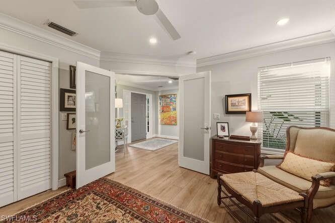 254 Edgemere Way East Naples, FL 34105 - Photo 18 of 41 Sitting room featuring french doors, light wood-style flooring, crown molding, ceiling fan, and recessed lighting