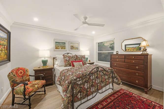 254 Edgemere Way East Naples, FL 34105 - Photo 23 of 41 Bedroom featuring light wood finished floors, crown molding, a ceiling fan, and recessed lighting