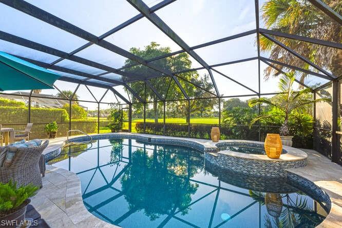 254 Edgemere Way East Naples, FL 34105 - Photo 28 of 41 View of swimming pool featuring a sunroom, a pool with connected hot tub, a lanai, and a patio area