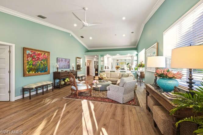 254 Edgemere Way East Naples, FL 34105 - Photo 6 of 41 Living room with lofted ceiling, ornamental molding, wood finished floors, and a ceiling fan