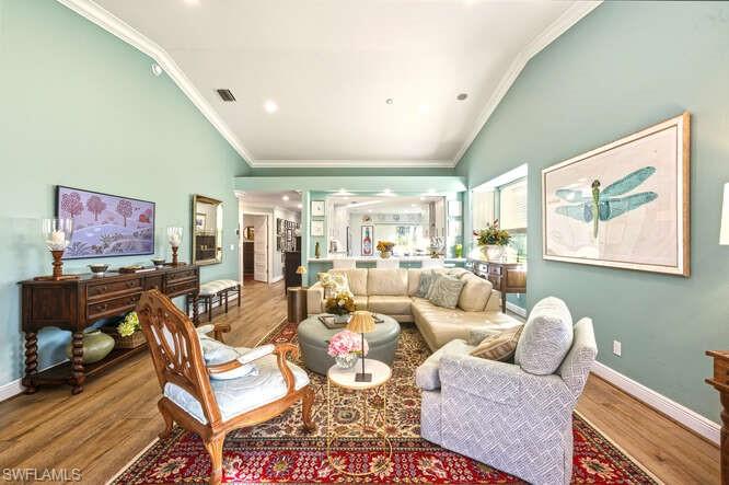 254 Edgemere Way East Naples, FL 34105 - Photo 8 of 41 Living room featuring wood finished floors, ornamental molding, high vaulted ceiling, and recessed lighting