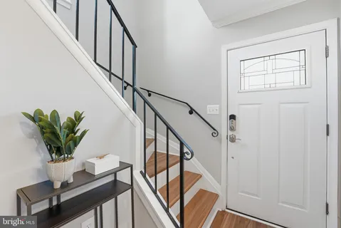 a view of entryway with wooden floor and stairs