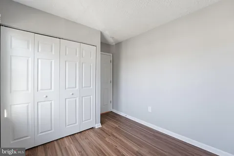 a view of an empty room and wooden floor