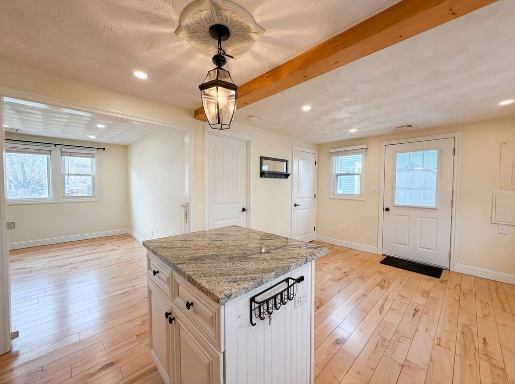 125 Burnham Road Lowell, MA 01852 - Photo 11 of 19 an empty room with wooden floor and ceiling fan