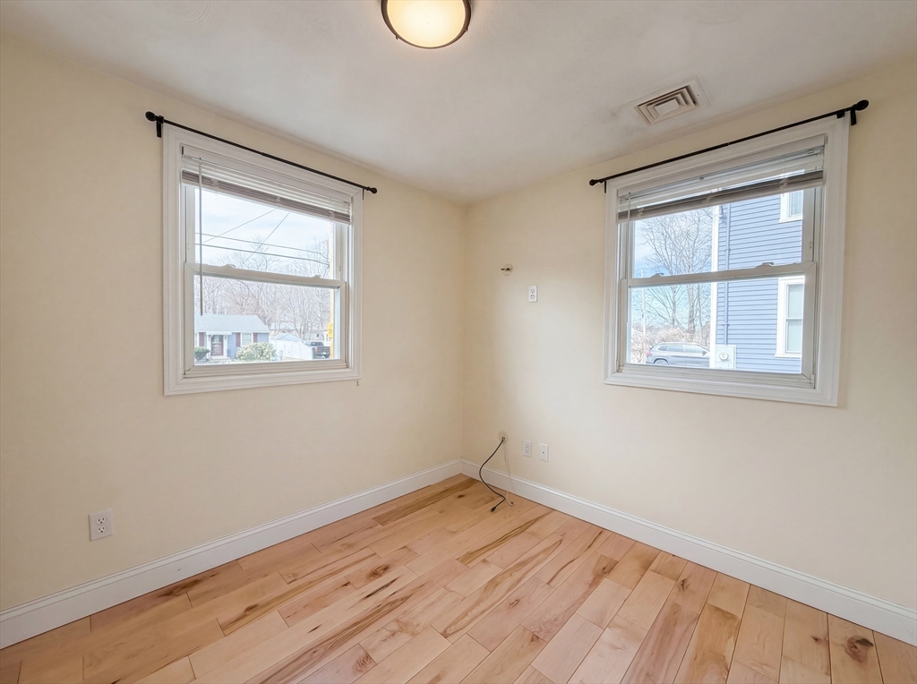 125 Burnham Road Lowell, MA 01852 - Photo 17 of 19 a view of empty room with wooden floor and fan