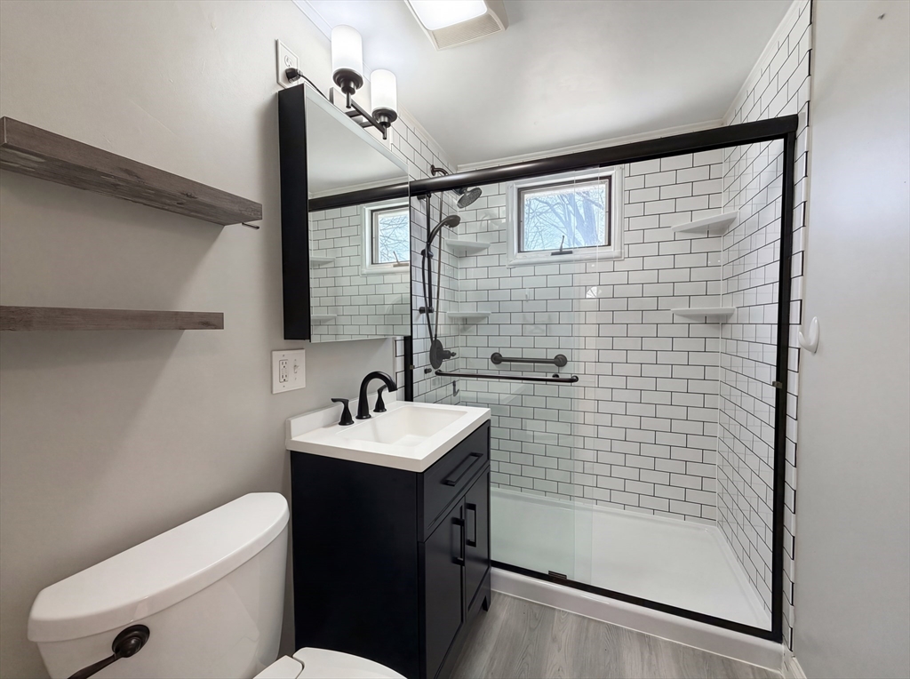 125 Burnham Road Lowell, MA 01852 - Photo 6 of 19 a bathroom with a sink a toilet and shower