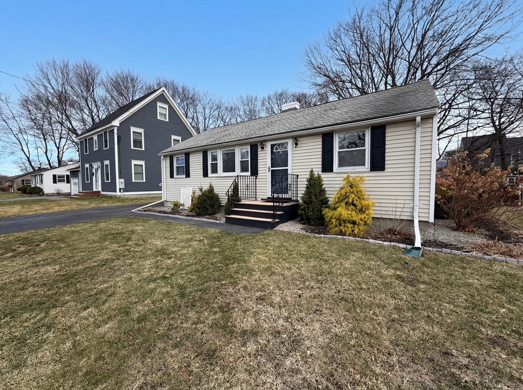 125 Burnham Road Lowell, MA 01852 - Photo 8 of 19 a front view of a house with garden