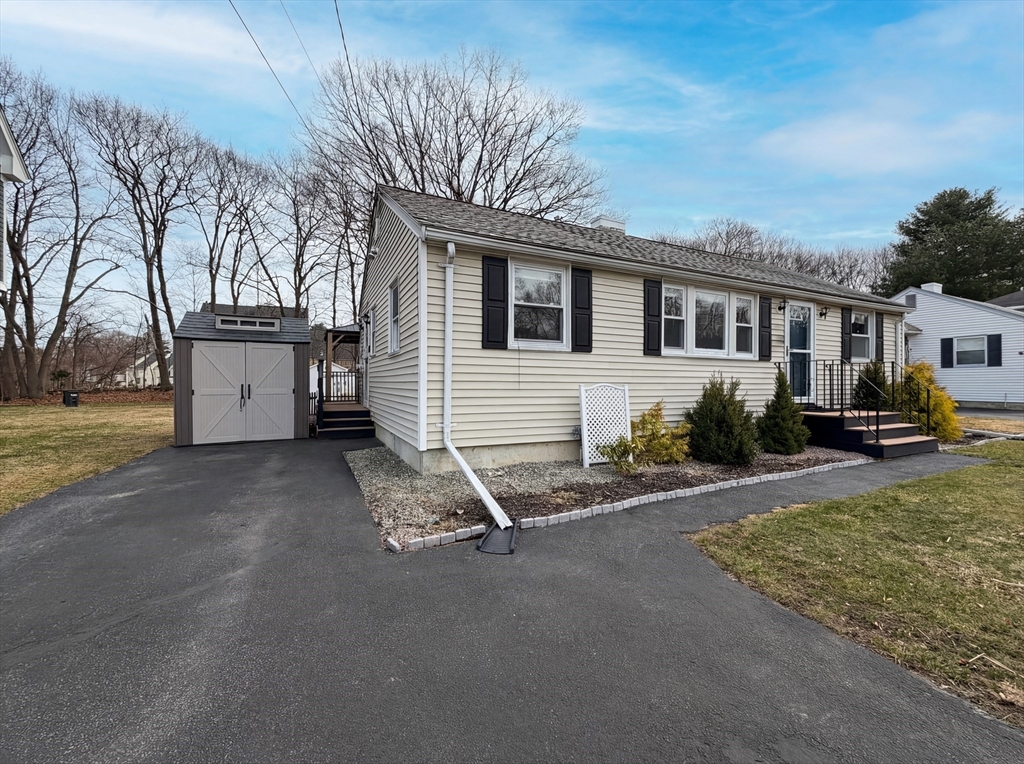 125 Burnham Road Lowell, MA 01852 - Photo 9 of 19 a view of a house with a patio