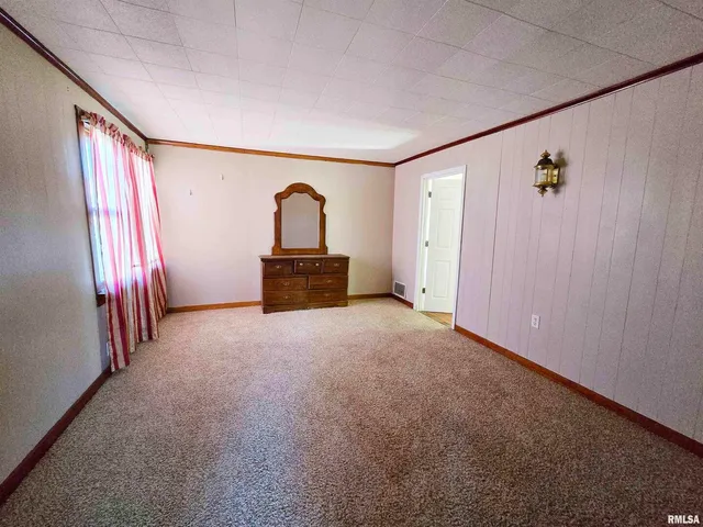 a view of a bedroom with wooden floor and a window