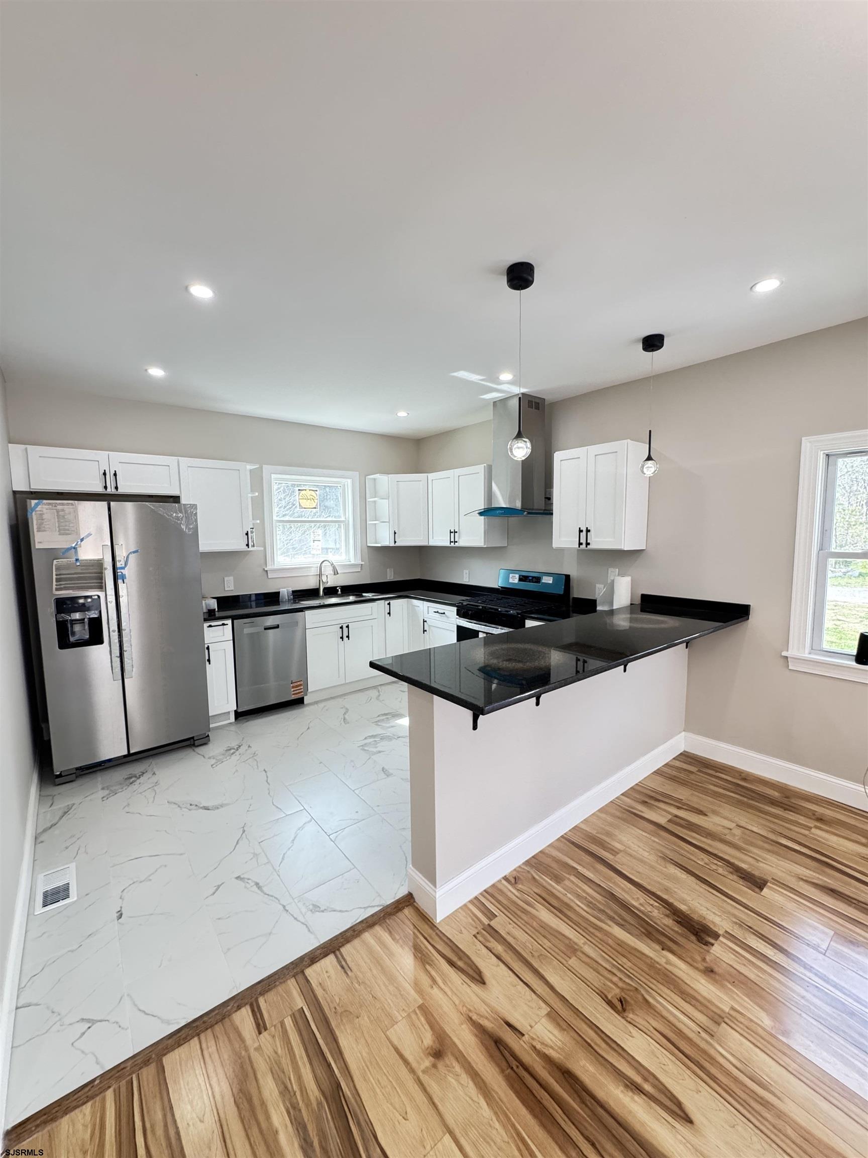 172 Old Port Republic Road Galloway Township, NJ 08205 - Photo 13 of 35 a large white kitchen with stainless steel appliances granite countertop a refrigerator sink and cabinets