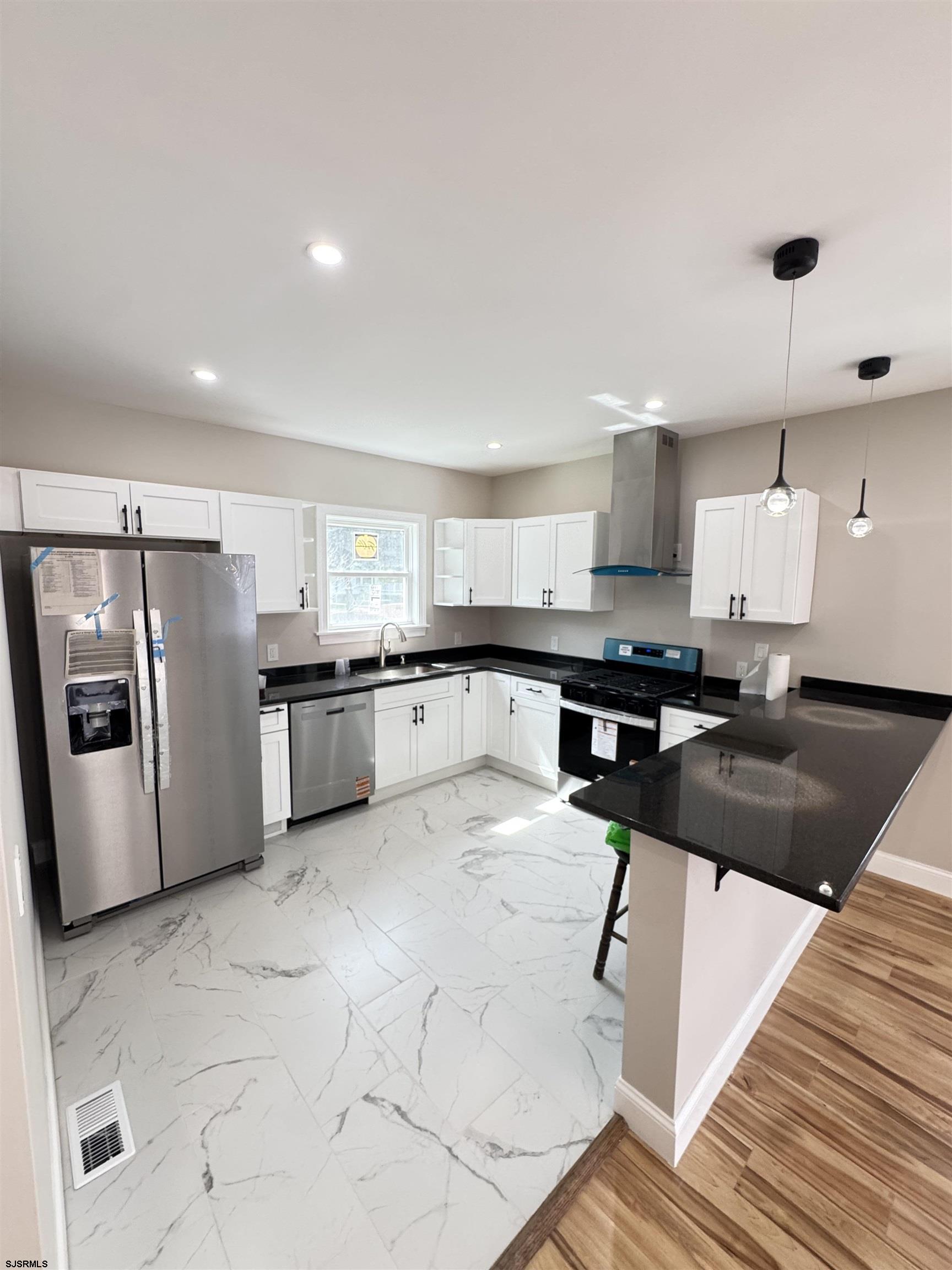 172 Old Port Republic Road Galloway Township, NJ 08205 - Photo 14 of 35 a kitchen with stainless steel appliances kitchen island granite countertop a refrigerator a stove a sink and a microwave