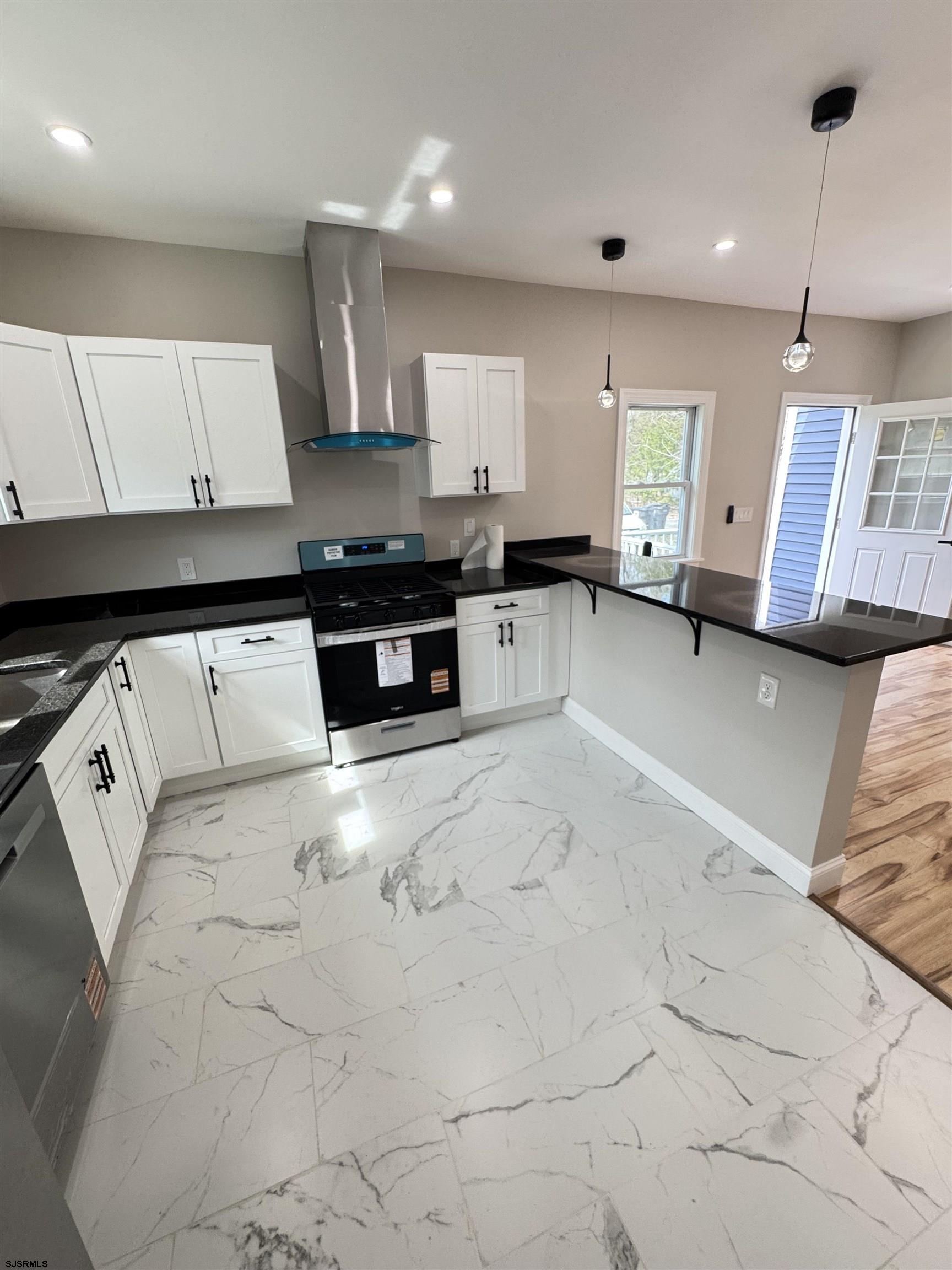 172 Old Port Republic Road Galloway Township, NJ 08205 - Photo 16 of 35 a large white kitchen with stainless steel appliances granite countertop lots of white cabinets a stove and a sink