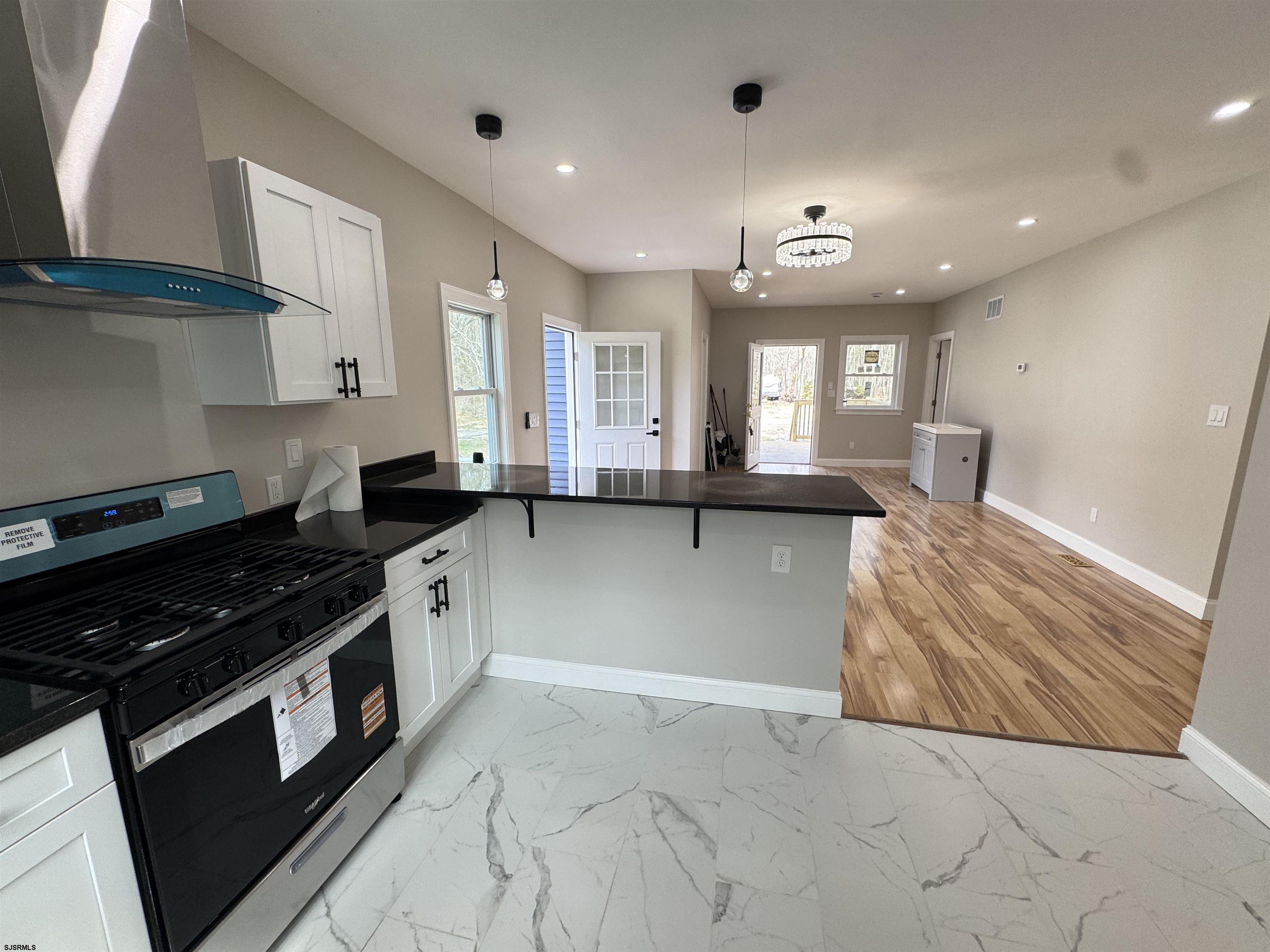 172 Old Port Republic Road Galloway Township, NJ 08205 - Photo 18 of 35 a kitchen with granite countertop a stove and a sink