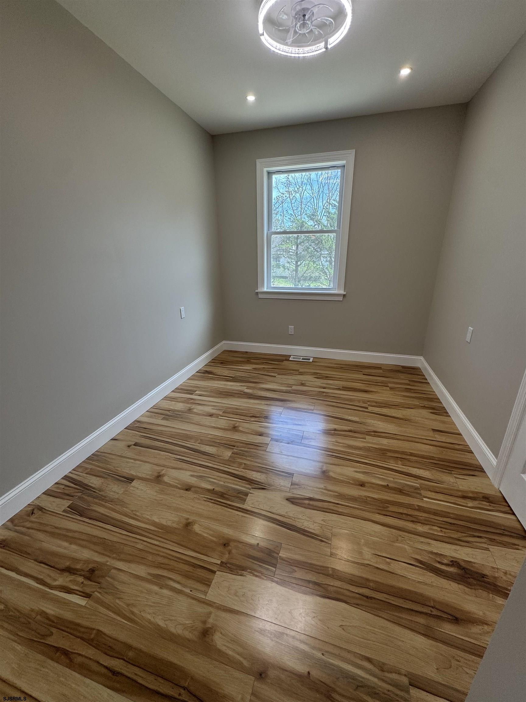 172 Old Port Republic Road Galloway Township, NJ 08205 - Photo 19 of 35 an empty room with wooden floor and window