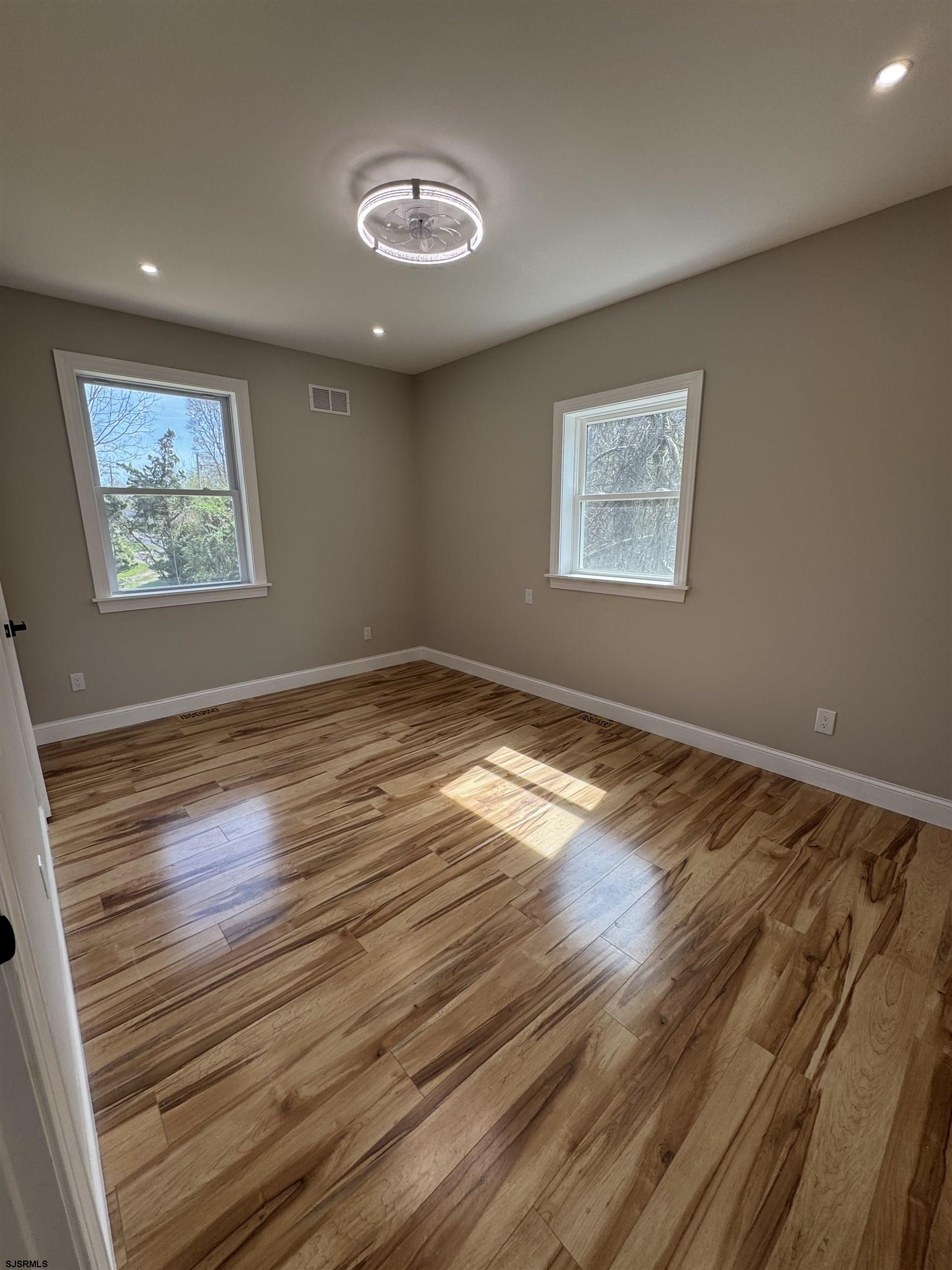 172 Old Port Republic Road Galloway Township, NJ 08205 - Photo 20 of 35 a view of an empty room with wooden floor and a window
