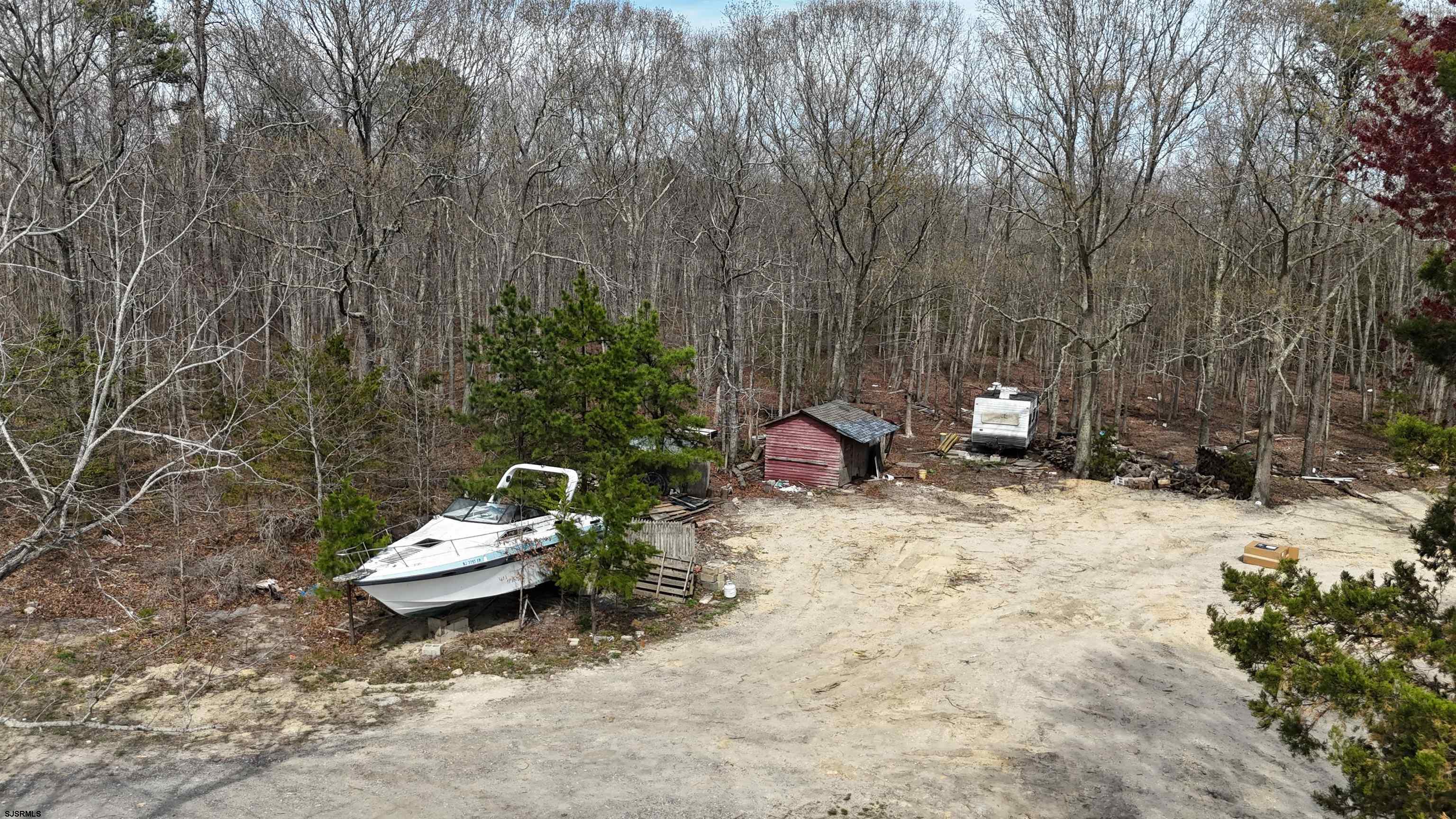 172 Old Port Republic Road Galloway Township, NJ 08205 - Photo 33 of 35 a view of a backyard with a fire pit and a tall tree