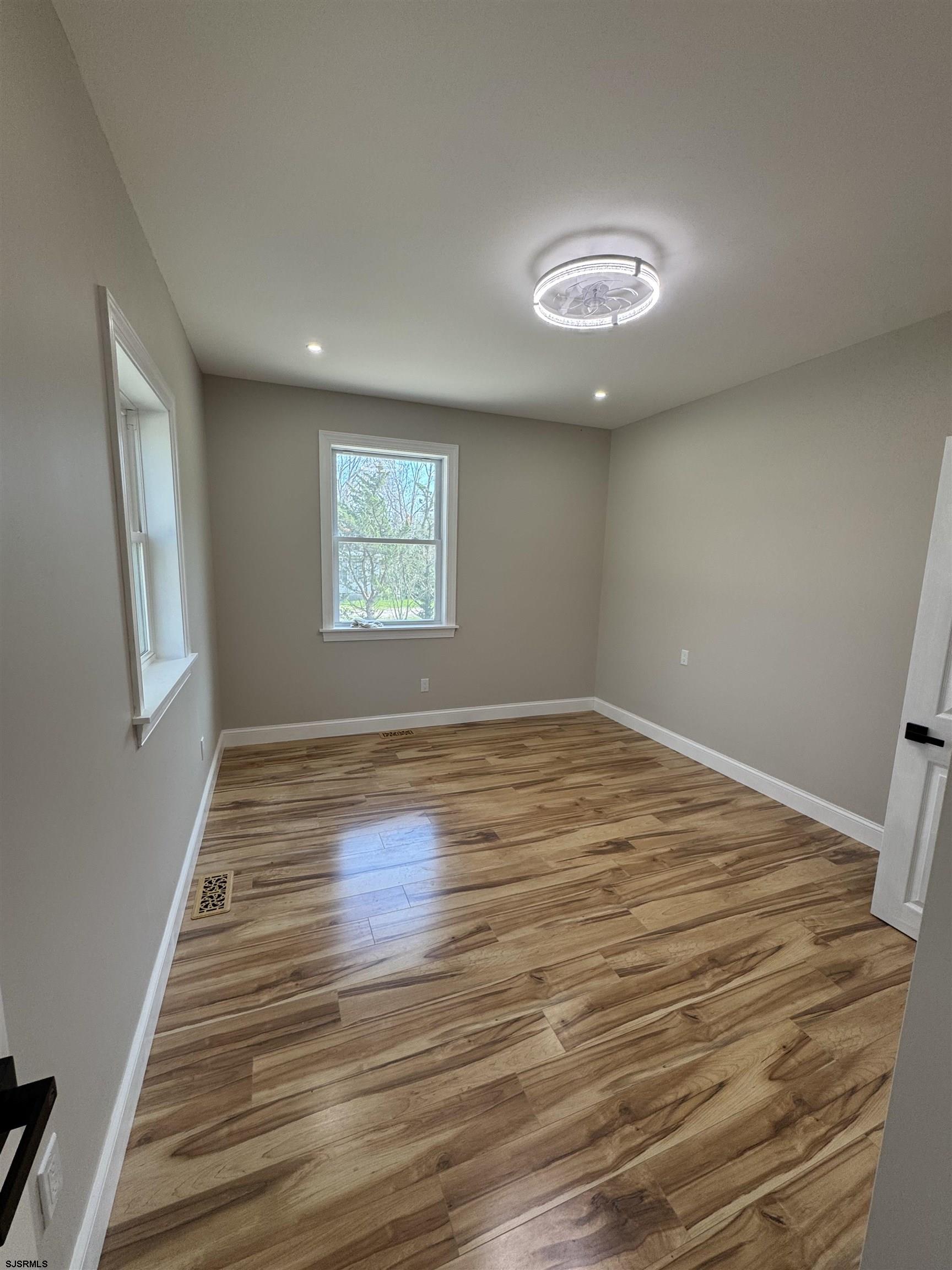 172 Old Port Republic Road Galloway Township, NJ 08205 - Photo 7 of 35 an empty room with wooden floor and windows
