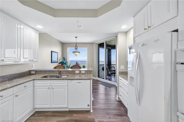 a spacious bathroom with a granite countertop sink mirror and a shower