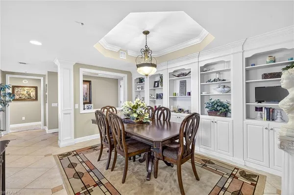a dining room with furniture window and wooden floor
