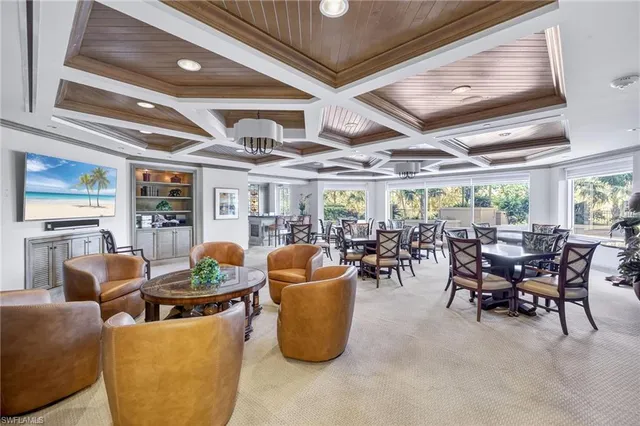 a dining room with furniture and a large window