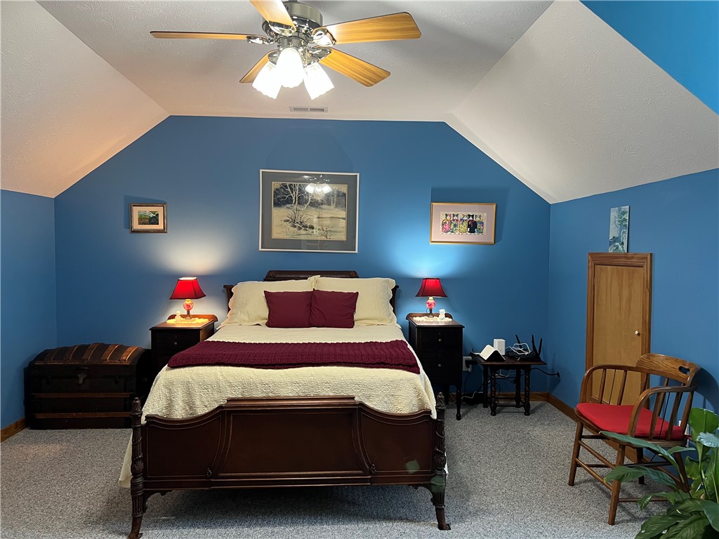 1419 Mill Creek Road Wake, VA 23176 - Photo 38 of 49 Carpeted bedroom featuring a ceiling fan, vaulted ceiling, and a textured ceiling