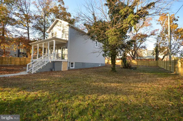 a front view of house with trees