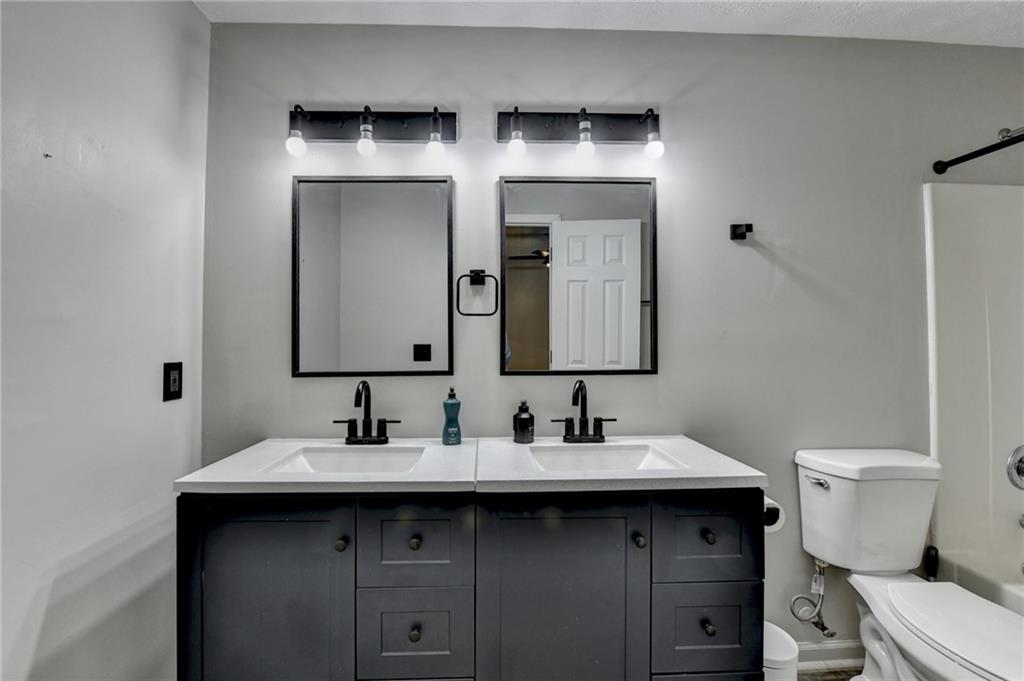801 Davis Street Monroe, GA 30655 - Photo 27 of 33 a bathroom with a toilet sink and mirror