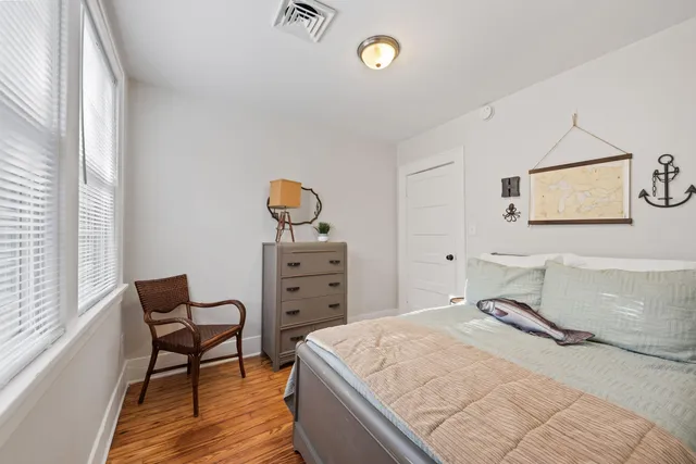 a bedroom with a bed and chair