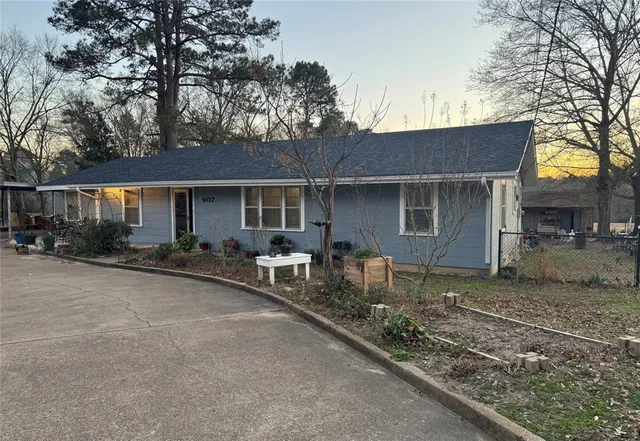 a backyard of a house with table and chairs