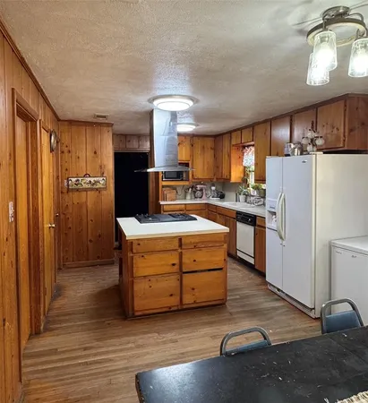 a kitchen with refrigerator a sink and cabinets