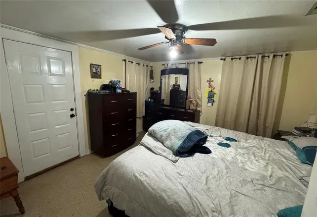 a bedroom with a bed and a mirror on dresser