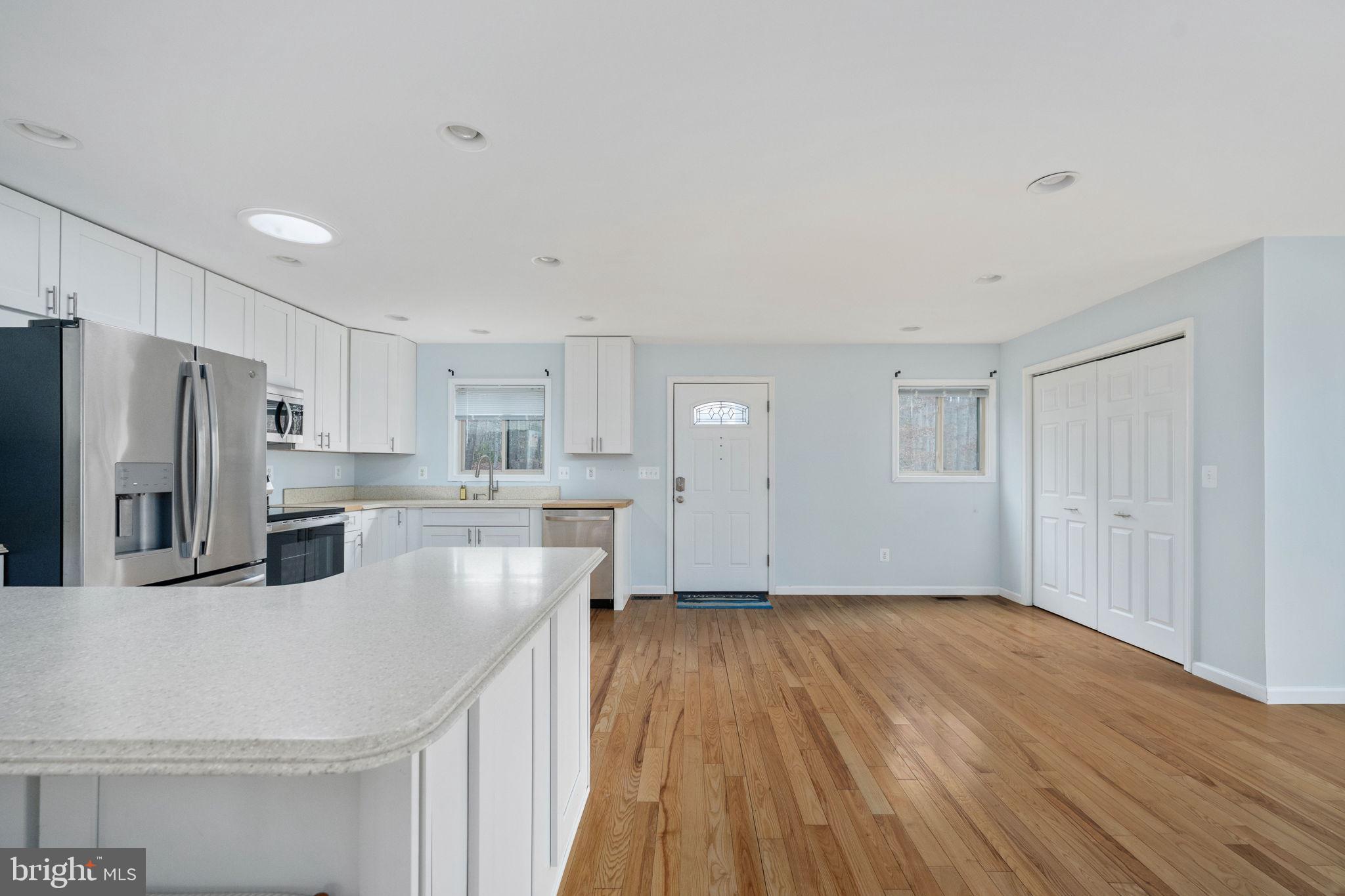 10706 Ropers Run Bumpass, VA 23024 - Photo 15 of 76 a kitchen with kitchen island white cabinets and stainless steel appliances