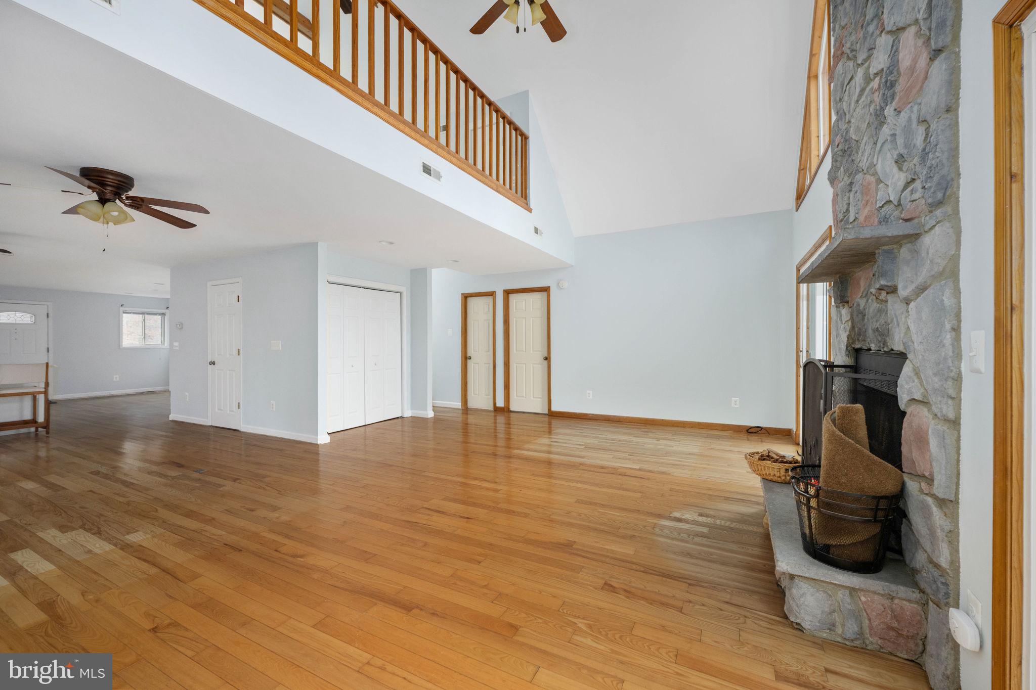 10706 Ropers Run Bumpass, VA 23024 - Photo 22 of 76 a view of a livingroom with wooden floor and a ceiling fan