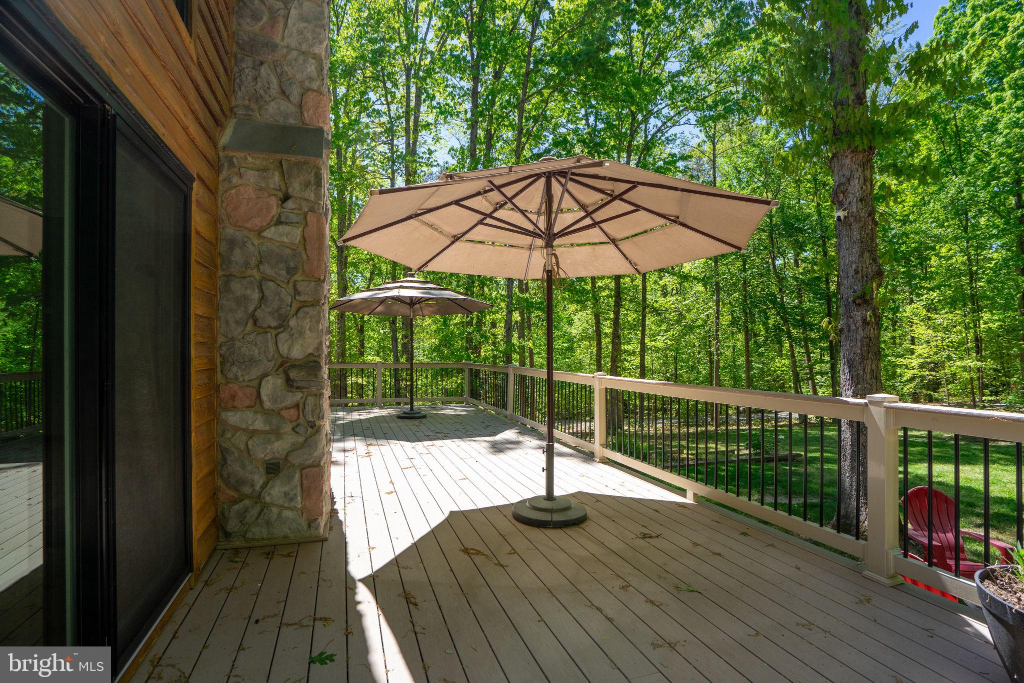 10706 Ropers Run Bumpass, VA 23024 - Photo 50 of 76 a view of balcony with wooden floor and umbrella