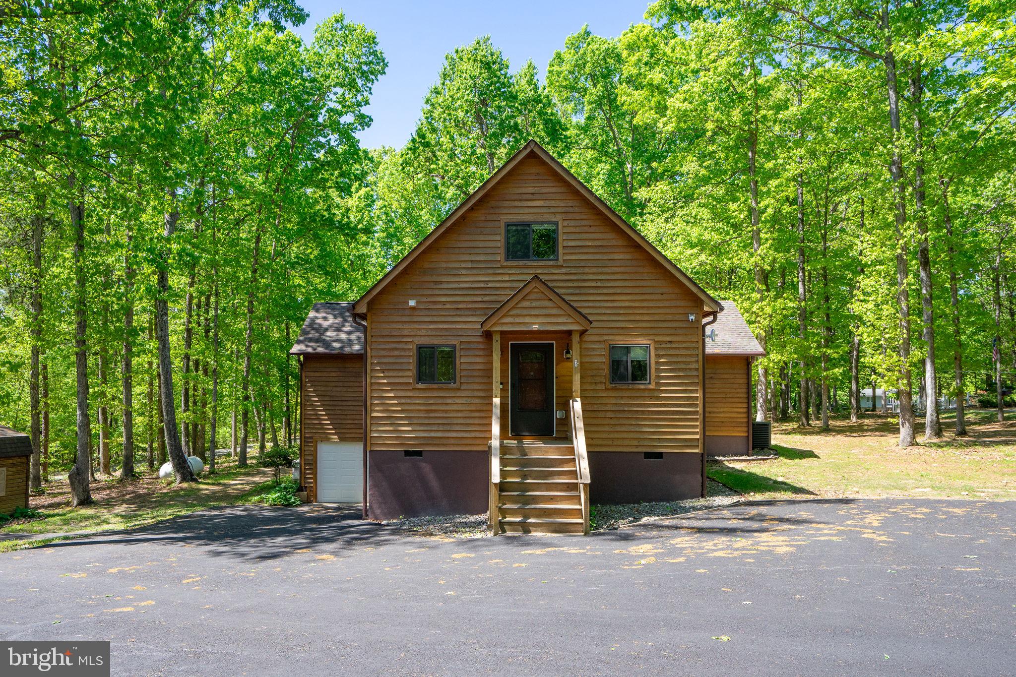 10706 Ropers Run Bumpass, VA 23024 - Photo 67 of 76 a view of a house that has a small yard and large trees